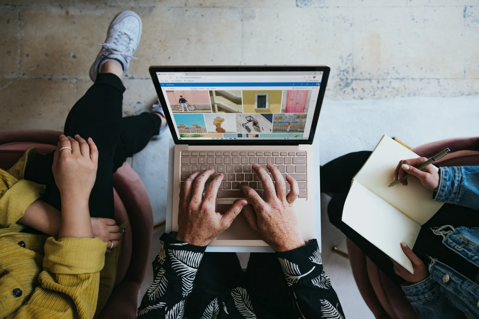 Align PPC Ads With Landing Pages for Higher Conversions image person using microsoft surface laptop on lap with two other people