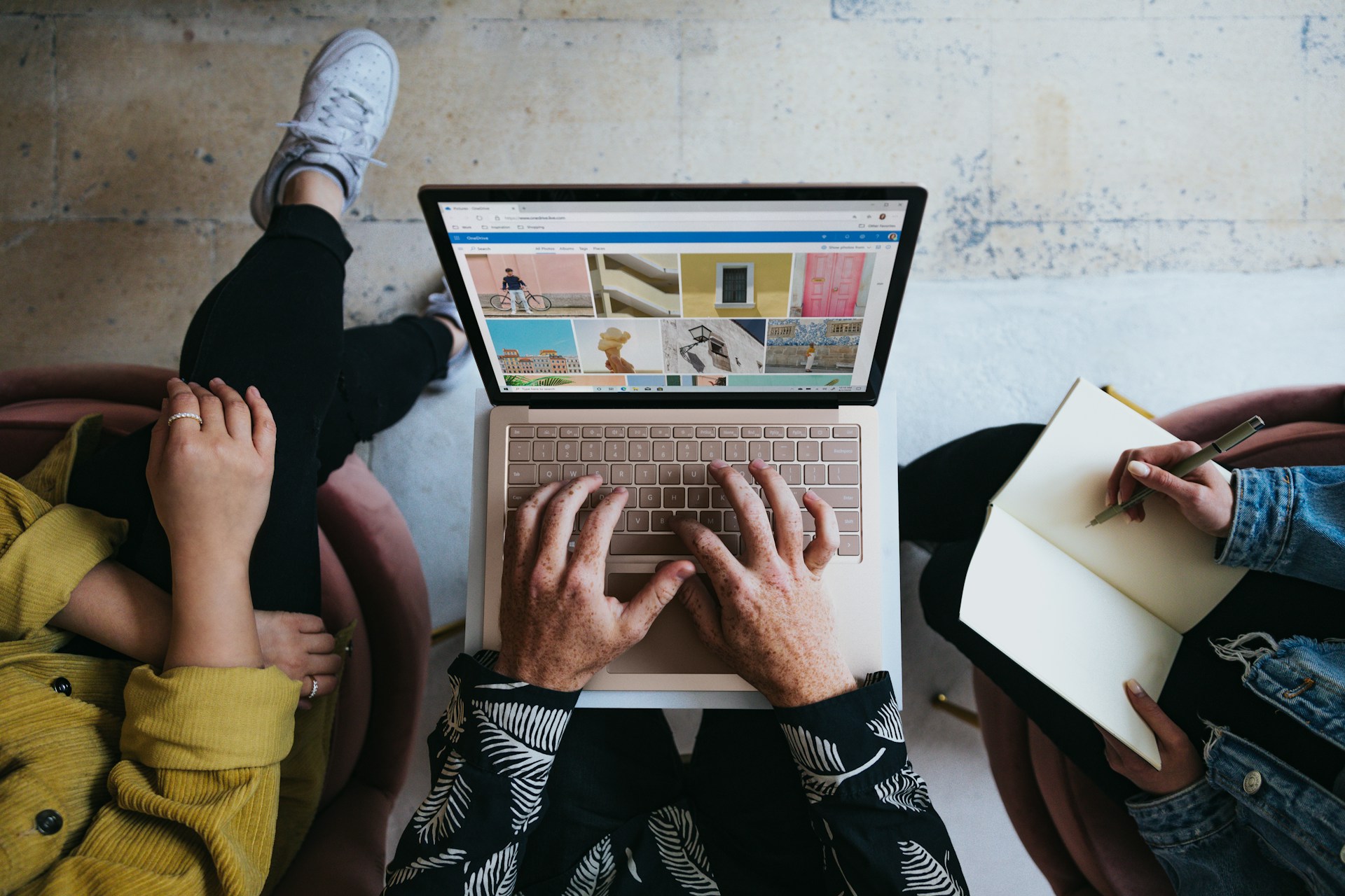 Align PPC Ads With Landing Pages for Higher Conversions image person using microsoft surface laptop on lap with two other people